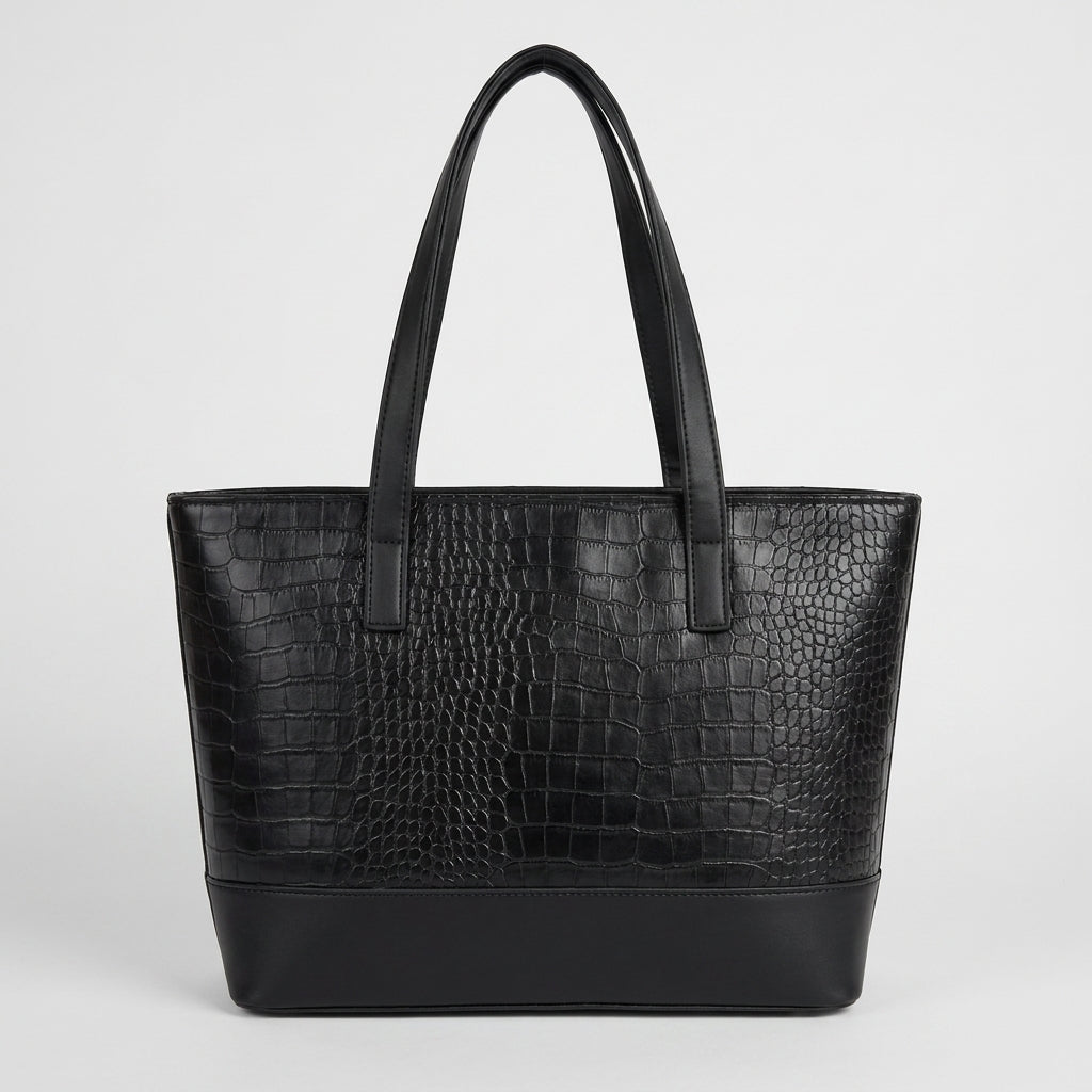 A black crocodile-embossed leather tote bag with dual top handles and a solid black base, photographed against a light gray studio background.