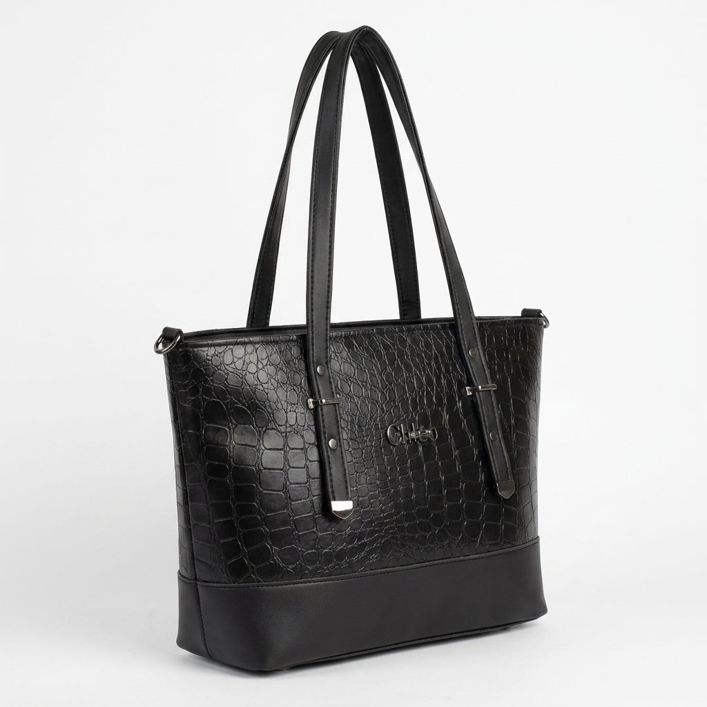 A black crocodile-embossed leather tote bag with dual shoulder straps and a silver-tone metal logo on the front, photographed on a clean white background.