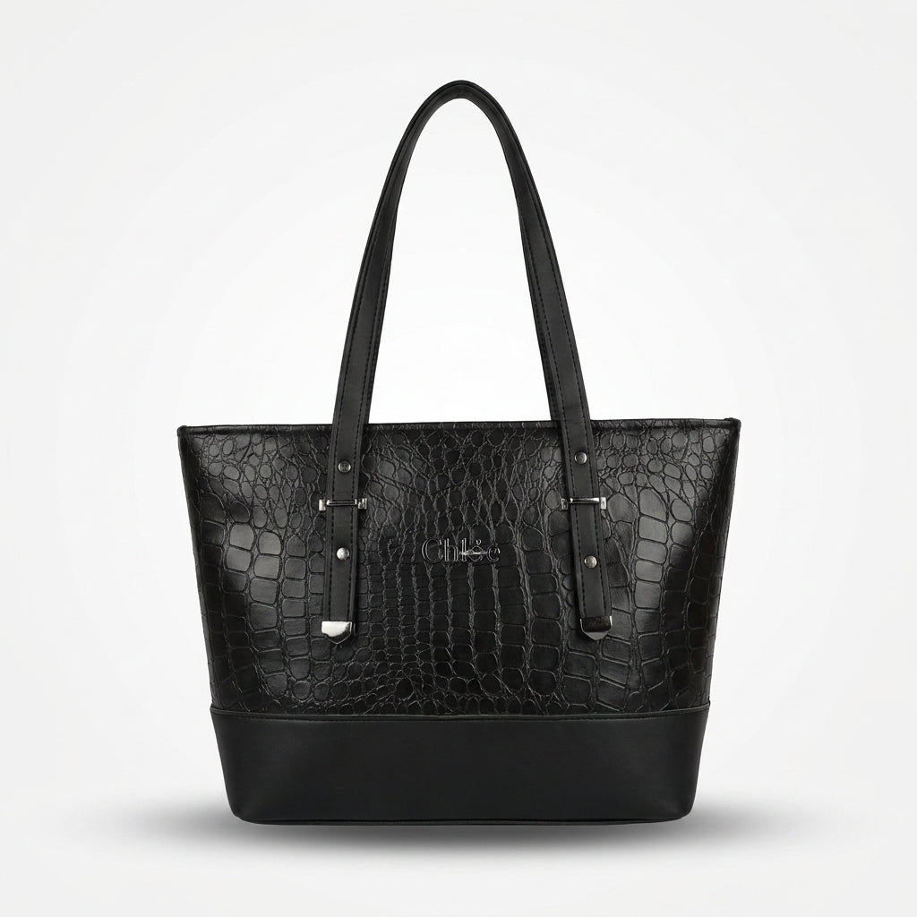 A black crocodile-embossed leather tote bag with dual shoulder straps and silver-tone hardware, shown against a light gray background.